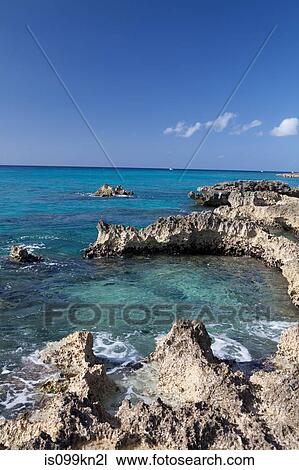 Stock Image - Rocks and Caribbean Sea, Grand Cayman, Cayman Islands. Fotosearch