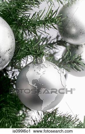 Silver globe bauble on christmas tree View Large Photo Image Stock Image - Silver globe bauble on christmas tree. Fotosearch