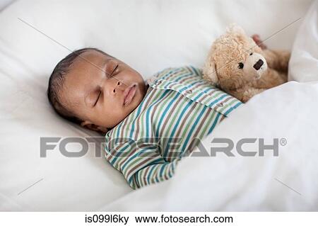 Sleeping baby in bed with teddy bear View Large Photo Image Stock Photo - Sleeping baby in bed with teddy bear. Fotosearch