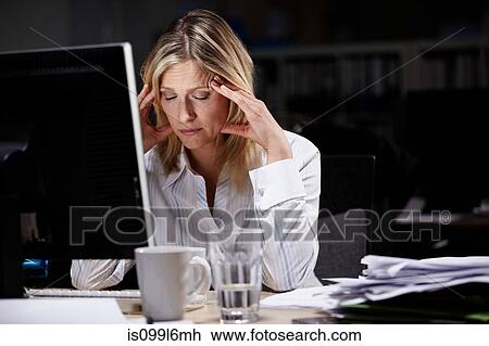 Stressed businesswoman working late View Large Photo Image Stock Image - Stressed businesswoman working late. Fotosearch