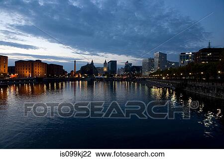 Stock Image - Sunset over waterfront out to Albert Dock and city skyline, Liverpool, UK. Fotosearch