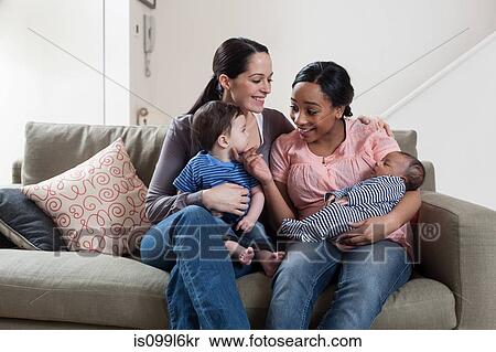 Stock Photography - Two mothers with their babies. Fotosearch