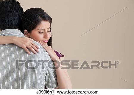 Woman hugging her husband View Large Photo Image Stock Photo - Woman hugging her husband. Fotosearch