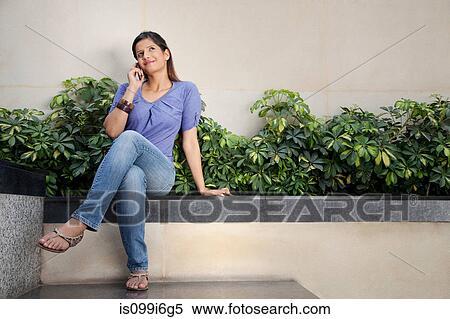Woman talking on a mobile phone View Large Photo Image Stock Photography - Woman talking on a mobile phone. Fotosearch