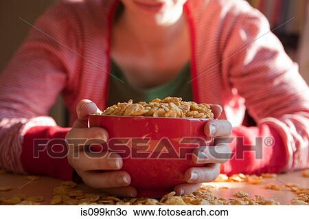 Woman with bowl and spilt breakfast cereal View Large Photo Image Picture - Woman with bowl and spilt breakfast cereal. Fotosearch