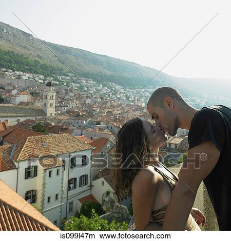 Picture - Young couple kissing above city of Dubrovnik, Croatia. Fotosearch