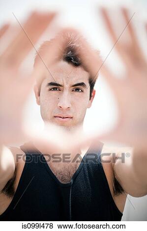 Stock Photo - Young man holding his hands out towards camera. Fotosearch