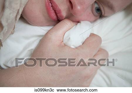 Young woman gripping bed sheet View Large Photo Image Stock Image - Young woman gripping bed sheet. Fotosearch