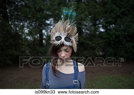 Young woman with feathered mask on her head View Large Photo Image Stock Image - Young woman with feathered mask on her head. Fotosearch