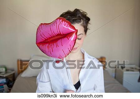 Young woman with lips-shaped balloon View Large Photo Image Stock Image - Young woman with lips-shaped balloon. Fotosearch