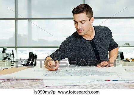 Architect working on blueprints in office View Large Photo Image Stock Photography - Architect working on blueprints in office. Fotosearch
