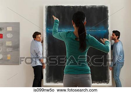 Art dealer arranging hanging of oil painting in gallery View Large Photo Image Picture - Art dealer arranging hanging of oil painting in gallery. Fotosearch