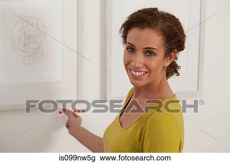 Art dealer placing sold dots under artwork in gallery View Large Photo Image Stock Image - Art dealer placing sold dots under artwork in gallery. Fotosearch