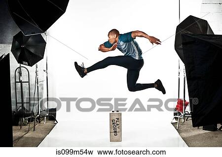 Athlete at photo shoot, jumping View Large Photo Image Stock Photo - Athlete at photo shoot, jumping. Fotosearch
