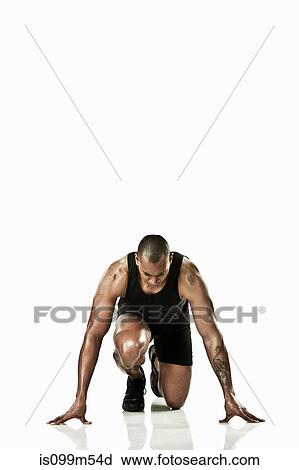 Stock Image - Athlete starting race. Fotosearch