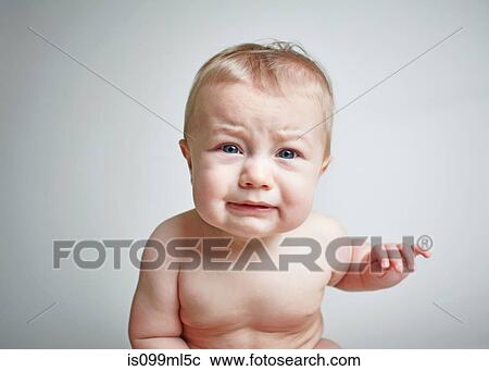 Stock Image - Baby boy looking upset. Fotosearch