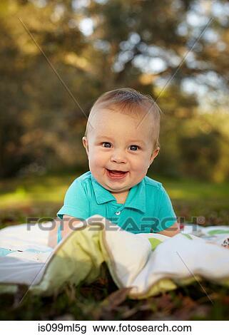 Stock Image - Baby boy on blanket in the park. Fotosearch
