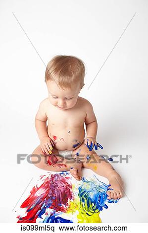 Baby looking at messy paint View Large Photo Image Stock Photography - Baby looking at messy paint. Fotosearch