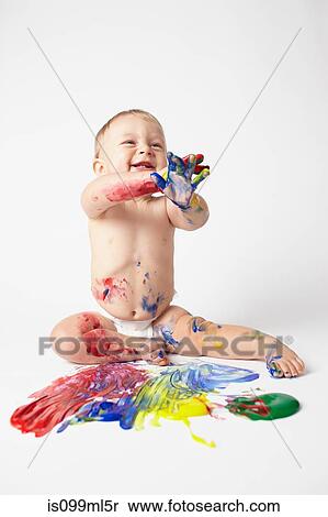 Stock Photography - Baby playing with paints. Fotosearch
