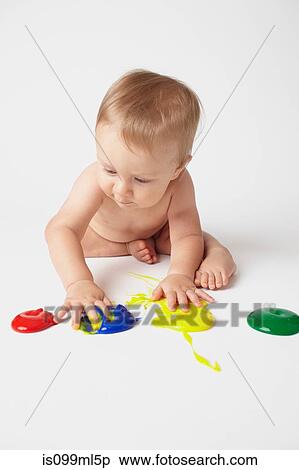 Baby putting hands in finger paints View Large Photo Image Stock Photography - Baby putting hands in finger paints. Fotosearch