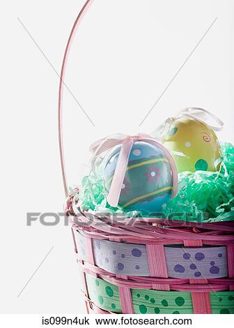 Stock Image - Basket of easter eggs, studio shot. Fotosearch