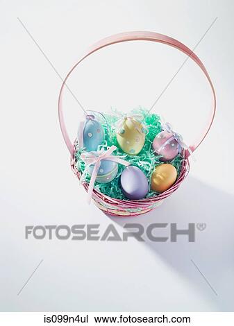 Stock Image - Basket of easter eggs, studio shot. Fotosearch