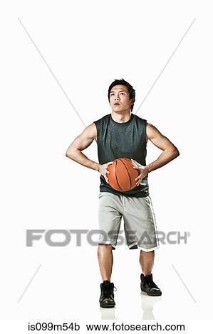 Basketball player holding ball View Large Photo Image Stock Image - Basketball player holding ball. Fotosearch