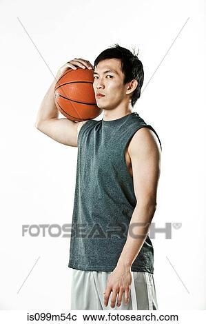 Basketball player holding ball View Large Photo Image Stock Image - Basketball player holding ball. Fotosearch