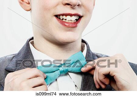 Boy adjusting bow tie View Large Photo Image Picture - Boy adjusting bow tie. Fotosearch