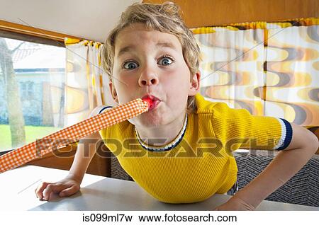 Boy blowing party blower in caravan View Large Photo Image Stock Photo - Boy blowing party blower in caravan. Fotosearch