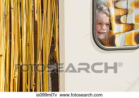 Boy looking through caravan window View Large Photo Image Stock Photo - Boy looking through caravan window. Fotosearch