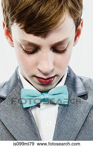 Boy wearing bow tie, looking down View Large Photo Image Stock Photo - Boy wearing bow tie, looking down. Fotosearch