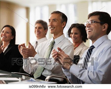 Business colleagues applauding in office View Large Photo Image Stock Photo - Business colleagues applauding in office. Fotosearch