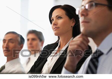 Business colleagues sitting in office meeting View Large Photo Image Stock Photo - Business colleagues sitting in office meeting. Fotosearch