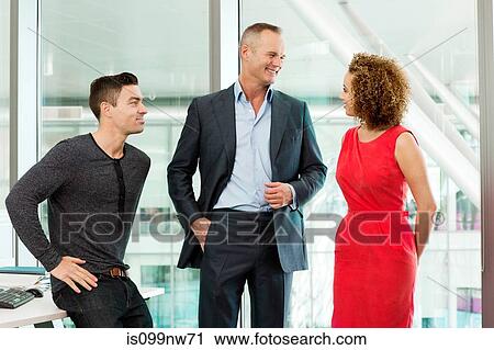 Business colleagues talking in office View Large Photo Image Stock Image - Business colleagues talking in office. Fotosearch