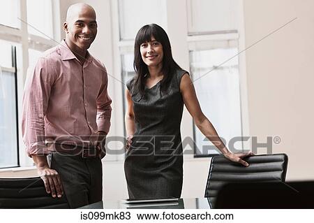 Businessman and businesswoman in office, portrait View Large Photo Image Stock Image - Businessman and businesswoman in office, portrait. Fotosearch
