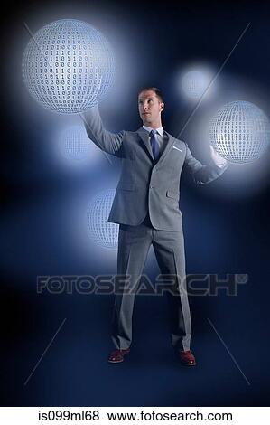 Businessman interacting with holographic binary globes View Large Photo Image Stock Photo - Businessman interacting with holographic binary globes. Fotosearch