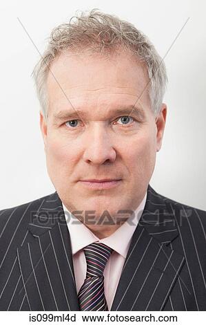 Stock Image - Businessman with serious expression, portrait. Fotosearch