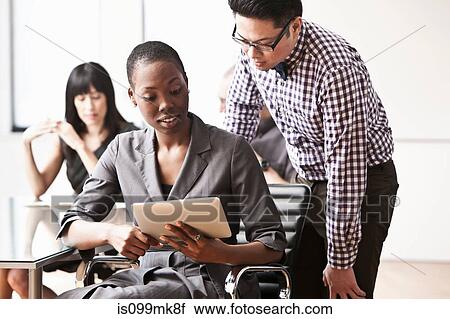 Businesspeople using digital tablet View Large Photo Image Stock Image - Businesspeople using digital tablet. Fotosearch