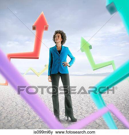 Businesswoman looking at holographic arrows in desert View Large Photo Image Stock Photo - Businesswoman looking at holographic arrows in desert. Fotosearch