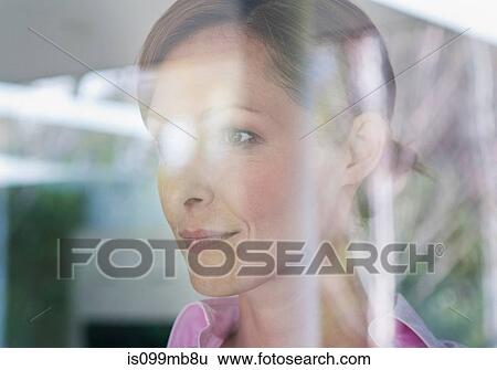 Businesswoman looking through window, portrait View Large Photo Image Stock Photograph - Businesswoman looking through window, portrait. Fotosearch