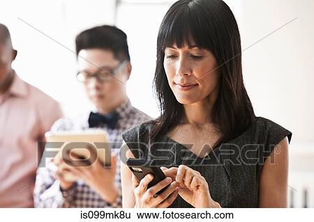 Stock Photograph - Businesswoman using handheld computer. Fotosearch