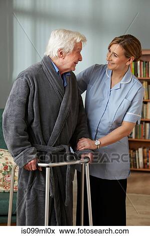 Carer assisting senior man using walking frame View Large Photo Image Stock Photo - Carer assisting senior man using walking frame. Fotosearch