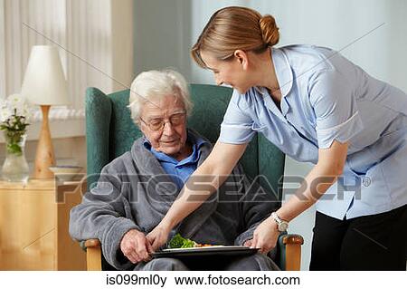 Stock Photo - Carer bringing meal to senior man. Fotosearch