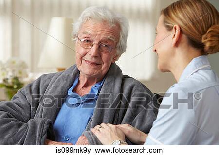 Carer touching senior mans arm View Large Photo Image Stock Photo - Carer touching senior mans arm. Fotosearch