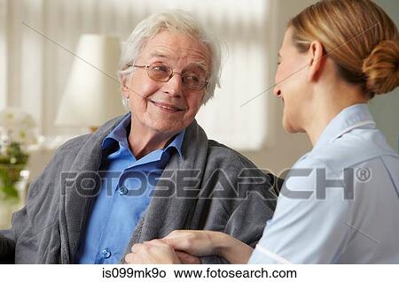 Carer touching senior mans hand View Large Photo Image Picture - Carer touching senior mans hand. Fotosearch