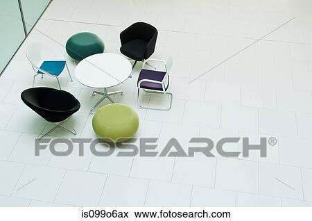 Chairs and table in empty office block, high angle view View Large Photo Image Stock Photo - Chairs and table in empty office block, high angle view. Fotosearch