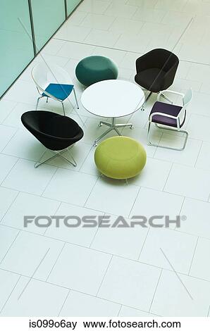 Chairs and table in empty office block, high angle view View Large Photo Image Stock Photo - Chairs and table in empty office block, high angle view. Fotosearch