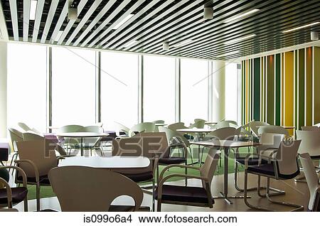 Picture - Chairs and tables in empty room of office block. Fotosearch