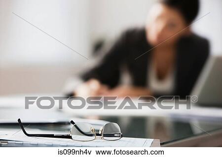 Close up of spectacles in office View Large Photo Image Stock Photo - Close up of spectacles in office. Fotosearch